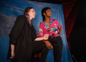 Belle leans against Tesh as they both look into the distance.